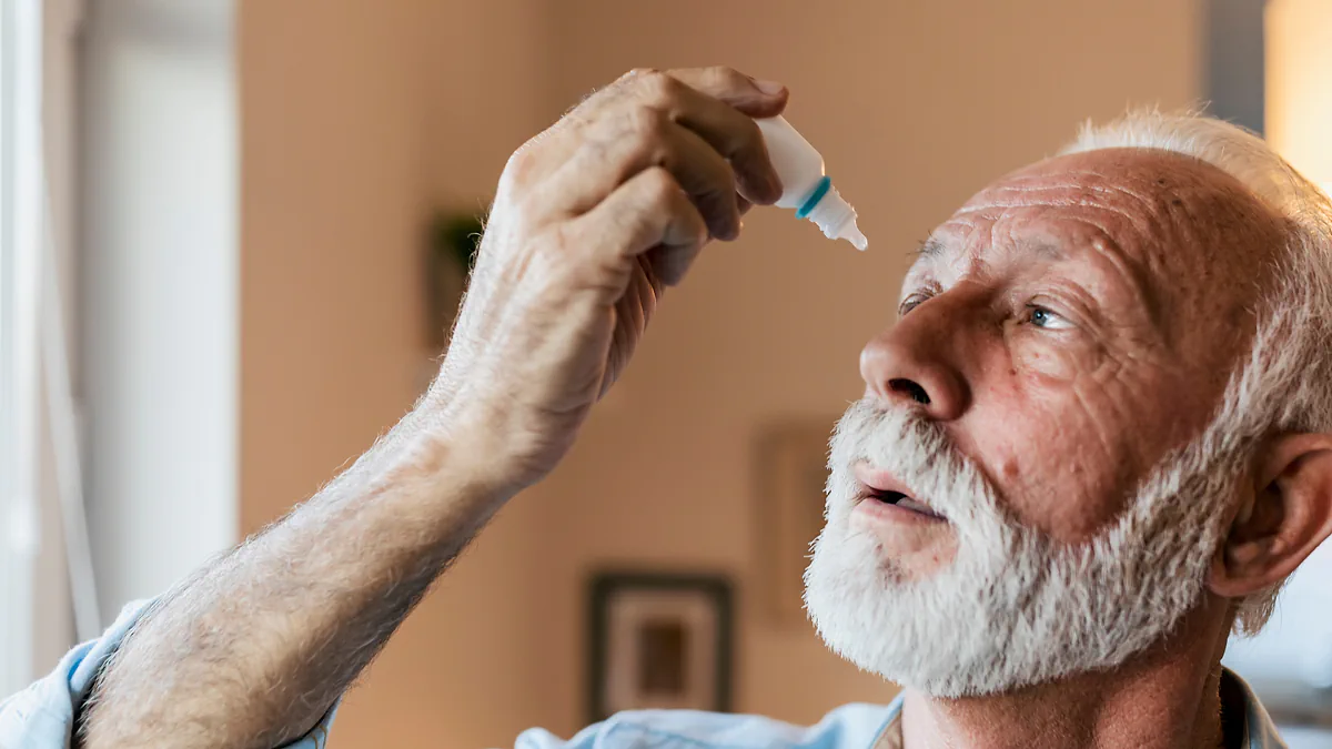 A close-up of an older man putting in eye drops