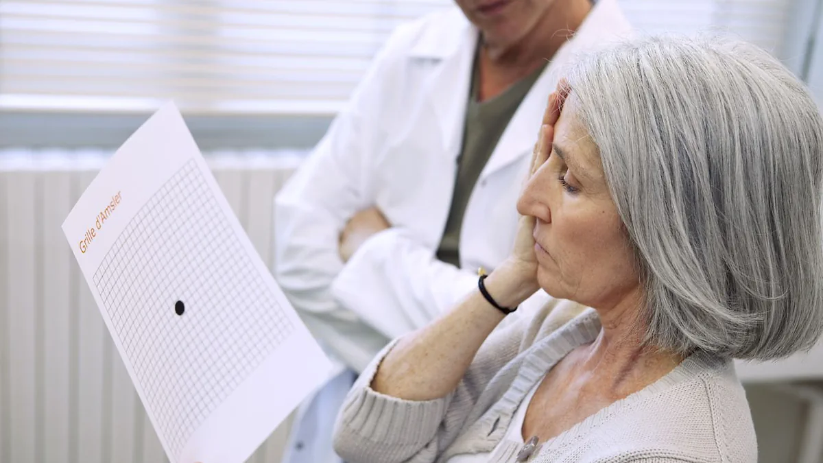 An older woman holding up an Amsler grid while a clinician looks on