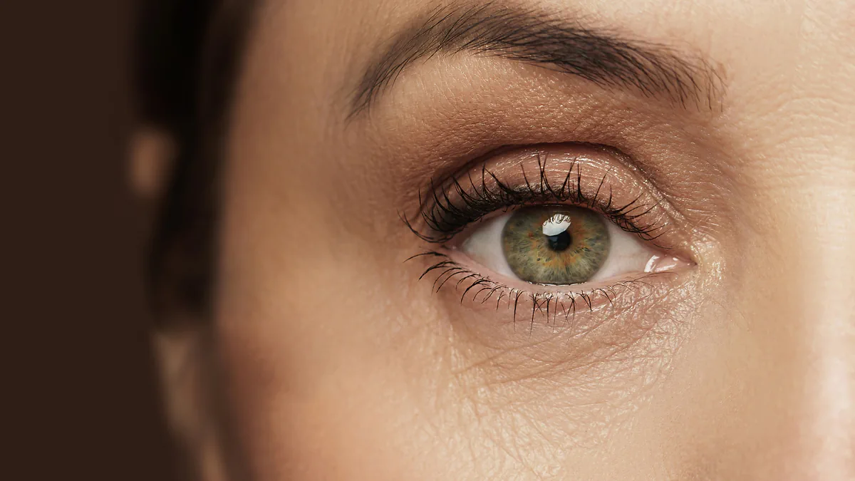 A close-up of a woman's green eye