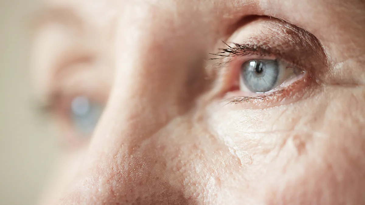 A close-up of an older person's blue eye