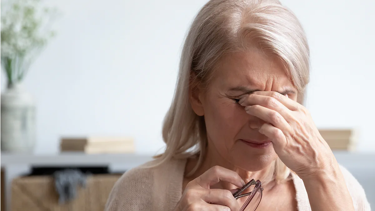 A woman rubbing her tired eyes